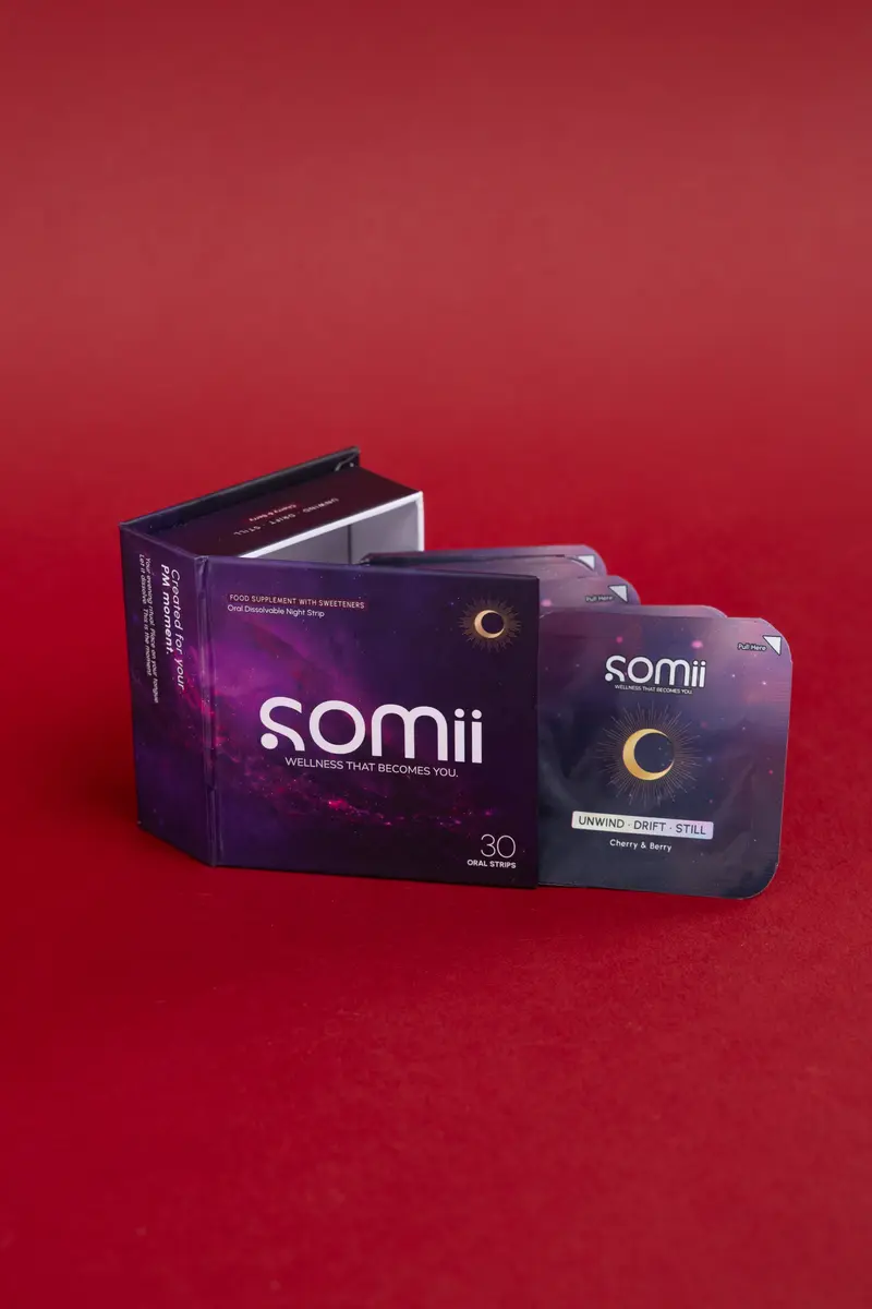 An open Somii evening box with its strip sachets on a red background