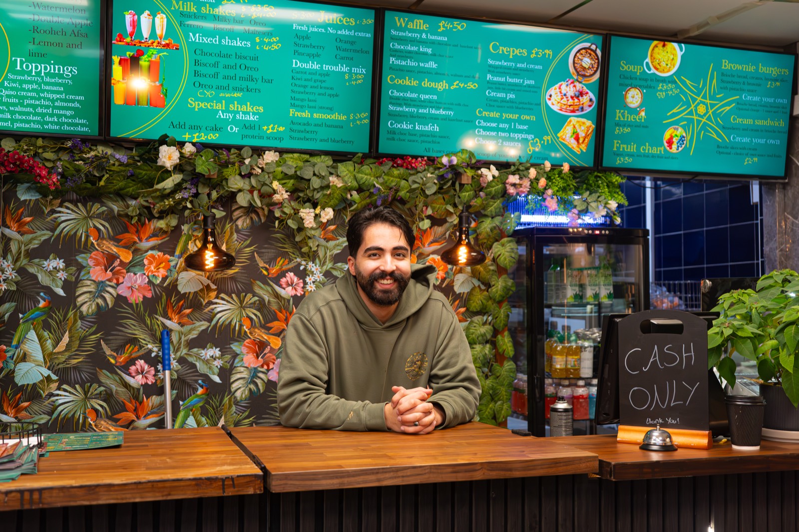 Anwar, owner of Qaiso Dessert Lounge, at the counter of his Birmingham dessert shop